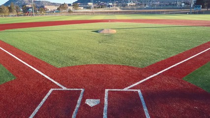 Red artificial turf baseball pitch