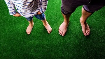 Bare feet on artificial grass.