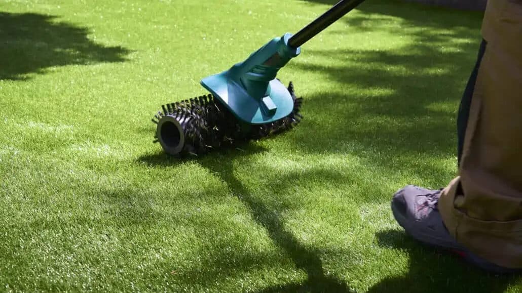 Roller brush on artificial turf