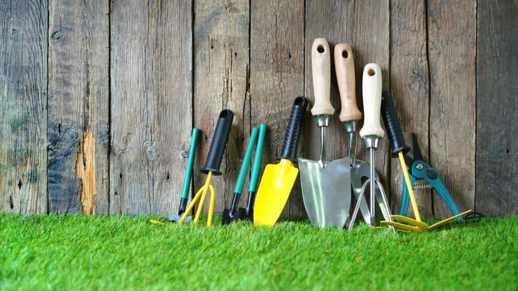 Gardening Tools on Artificial Turf by wooden fence