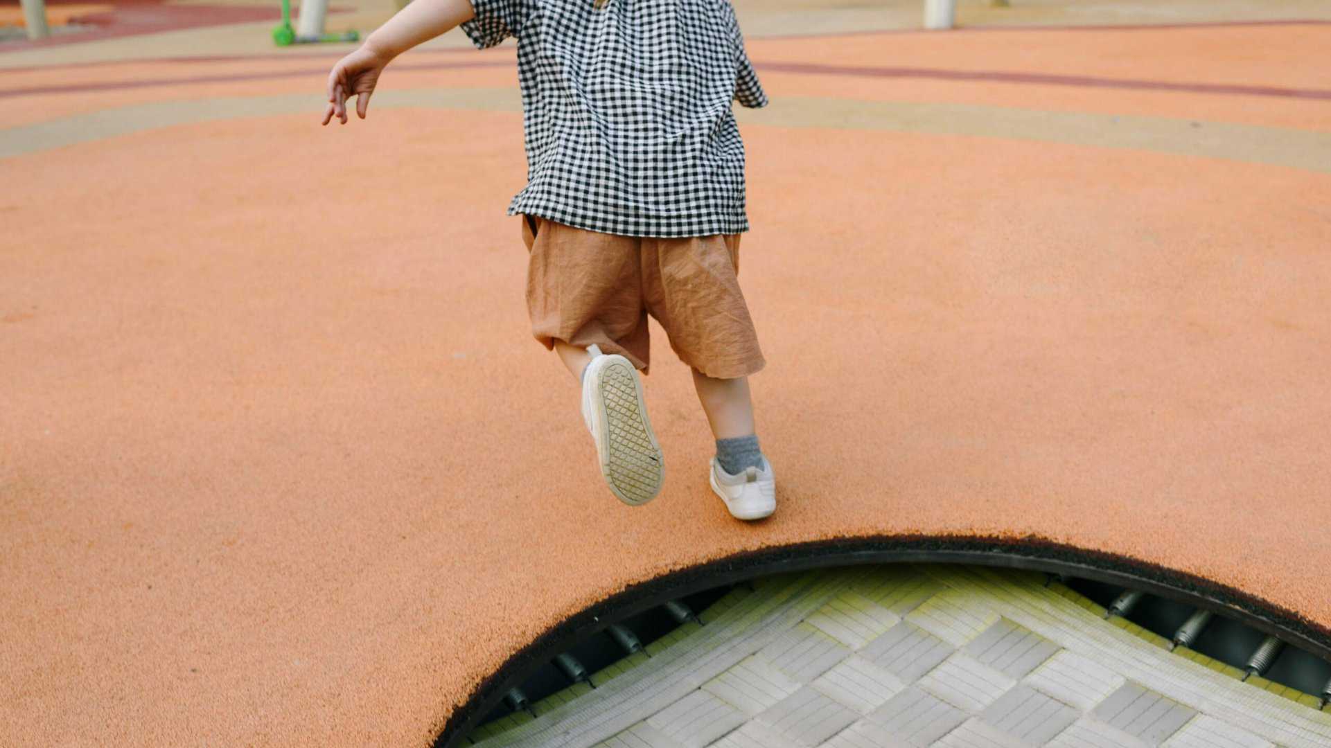 Child running on Rubber Ground Cover Playground