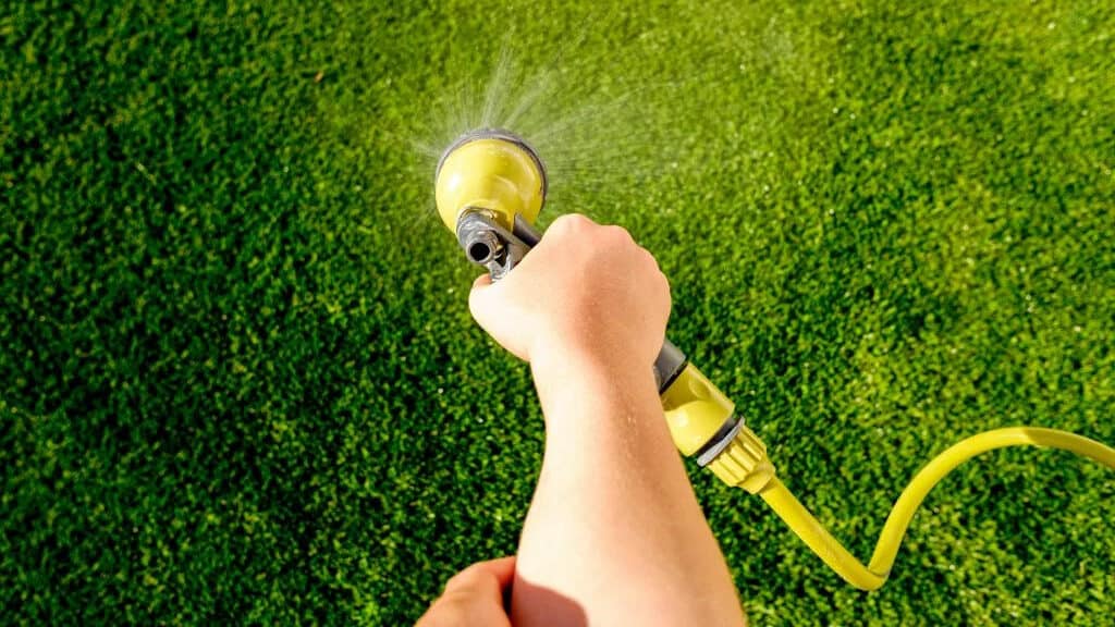 Spraying turf with water 