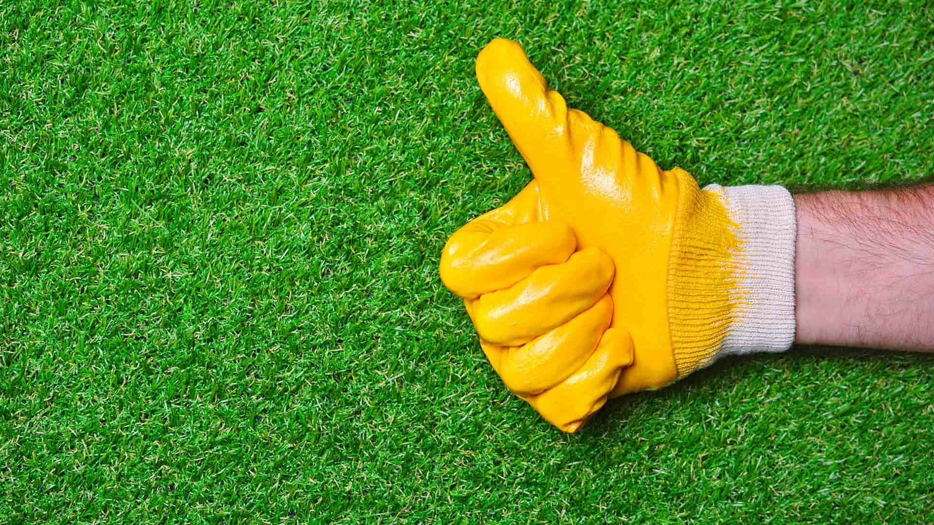 Thumbs Up Hand with Glove on Artificial Turf