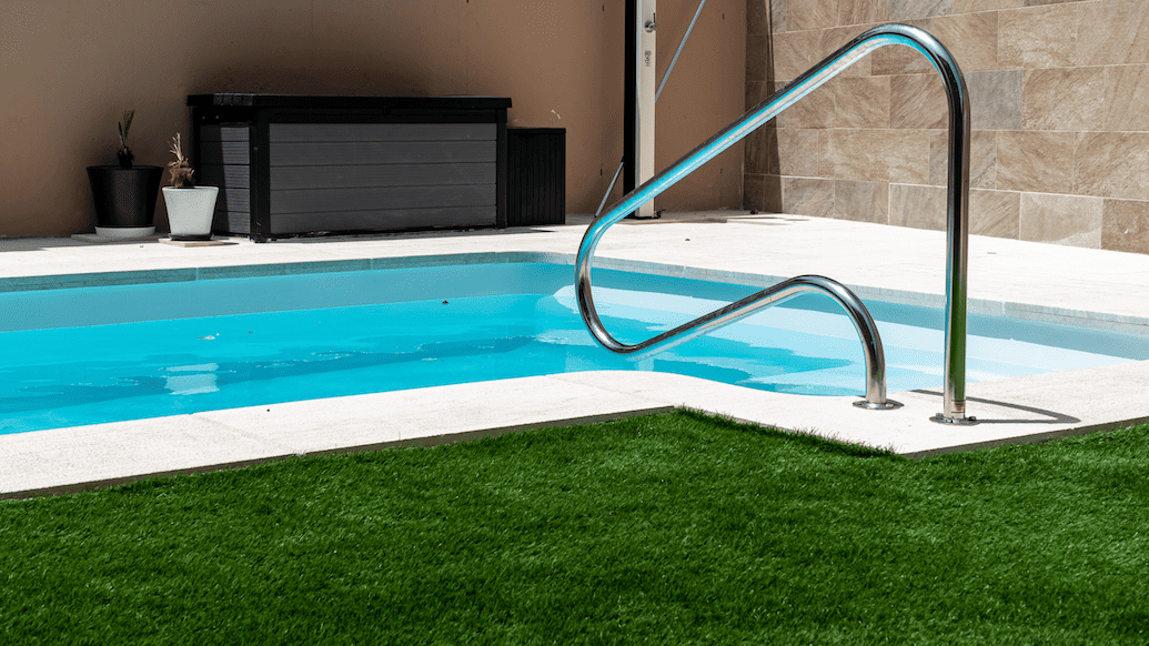 Pool with artificial turf around paving