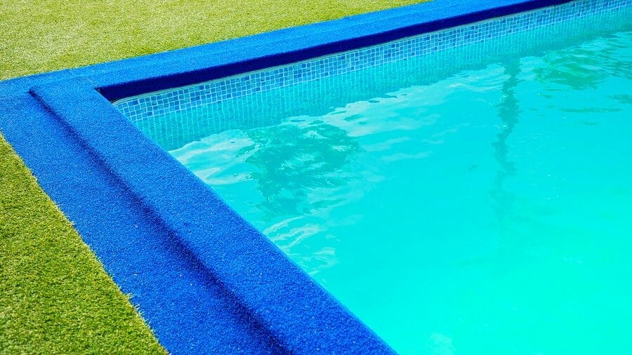 Green and blue artificial turf around pool