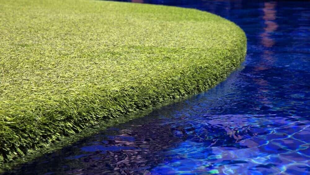 Clear Blue Water in Pool with Artificial Turf