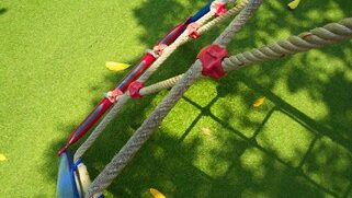 Playground with rope ladder and artificial turf