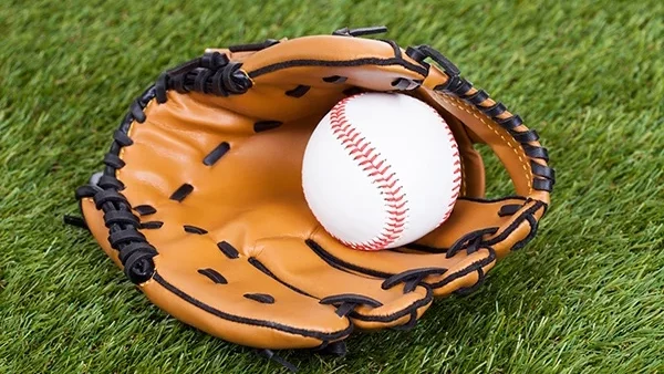 Baseball glove and ball on artificial turf